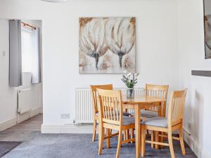a dining room with a wooden table and chairs at 2 bed in Bath 05135 in Chew Magna