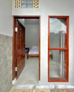 an open door to a bedroom with a bed at Caesarea Villa in Berastagi