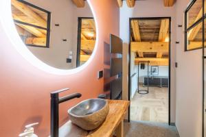 a bathroom with a stone sink and a mirror at SmartStay - Chalet Felix aux Confins in La Clusaz