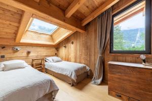 Ένα ή περισσότερα κρεβάτια σε δωμάτιο στο DIFY Chalet Contemporain - Les Praz de Chamonix