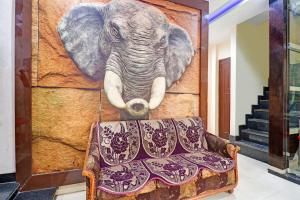 a painting of an elephant hanging on a wall at Super Collection O Hotel Shree Narayan Regency in Kānpur