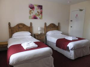 A bed or beds in a room at Novar Arms Hotel
