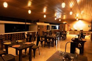 a dining room with tables and chairs in a restaurant at Goodland Falling Water Munnar in Munnar