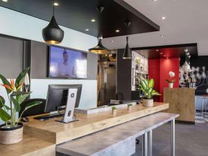 an office with a desk with a computer on it at ibis Cannes Plage La Bocca in Cannes