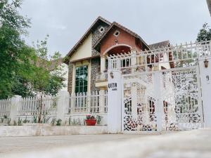a white fence in front of a house at vita homestay Măng Đen in Kon Von Kla