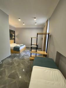 a bedroom with two beds and a chair in it at Be Italian Flat Sanfelice in Naples