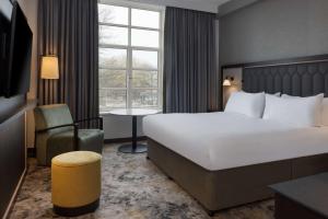a hotel room with a large bed and a window at Hilton Cardiff in Cardiff
