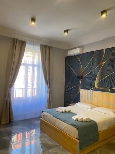 a bedroom with a bed with two towels on it at Be Italian Flat Sanfelice in Naples