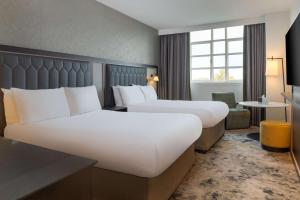 a hotel room with two beds and a window at Hilton Cardiff in Cardiff