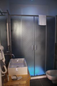 a bathroom with a shower with a toilet and a sink at Be Italian Flat Sanfelice in Naples