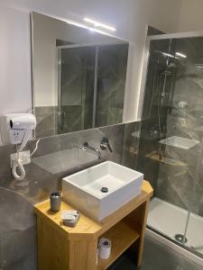 a bathroom with a white sink and a shower at Be Italian Flat Sanfelice in Naples
