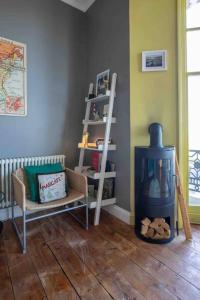 a living room with a wood stove and a chair at Bay View - Pet friendly in Margate