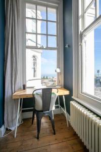 a desk with a chair in a room with a window at Bay View - Pet friendly in Margate