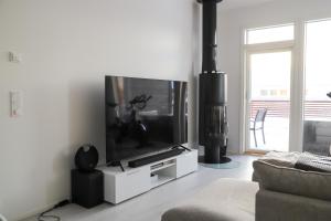 a living room with a large flat screen tv at Modern semi-detached house with wonderful location! in Rovaniemi