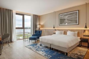 a hotel room with a bed and a desk and chair at Lake Hill Mazury, a member of Radisson Individuals in Ostróda