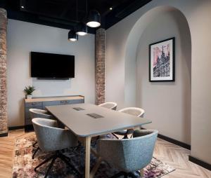 a meeting room with a table and chairs at Radisson RED Hotel, Liverpool in Liverpool