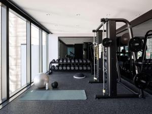 a gym with a bunch of equipment in a room at Novotel Perth Murray Street in Perth