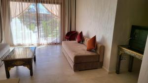 a living room with a couch and a glass table at Hôtel Jardins de lina et lea in Marrakesh