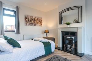 a bedroom with a bed and a fireplace at Honey's Hideaway in Hull