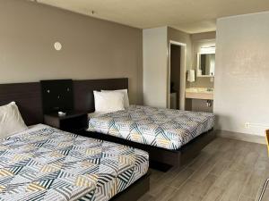 Un pat sau paturi într-o cameră la Motel 6 Cordele, GA