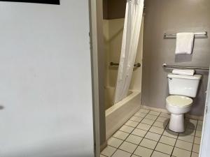 a bathroom with a toilet and a shower at Motel 6 Cordele, GA in Cordele