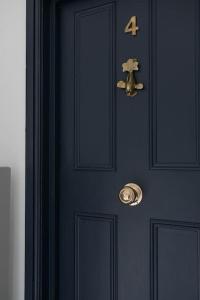 a blue door with a gold door knocker on it at Palm Heights - top floor luxury flat in Margate