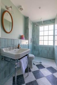 a bathroom with a sink and a toilet at Palm Heights - top floor luxury flat in Margate