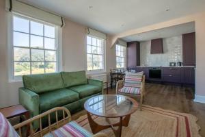a living room with a green couch and a table at Palm Heights - top floor luxury flat in Margate