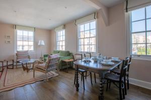 a living room with a table and a couch at Palm Heights - top floor luxury flat in Margate