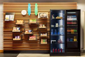a store with a refrigerator in front of a wall at Vienna House Easy by Wyndham Neckarsulm in Neckarsulm