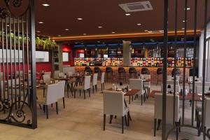 a restaurant with tables and chairs and a bar at Tryp by Wyndham Asuncion in Asuncion