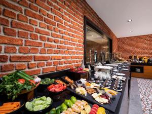 a buffet line with many different types of food at Tbilisi Saburtalo Hotel by Mercure in Tbilisi City