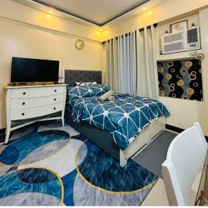a bedroom with a bed and a dresser and a tv at Cozy Corner Haven near Venice Grand Canal Mall in Manila +18 photos