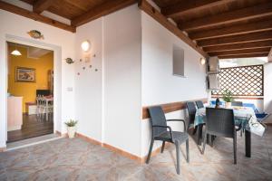 a kitchen and dining room with a table and chairs at Holiday vista mare in Cala Gonone