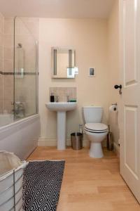 a bathroom with a toilet and a sink and a shower at SEA HEIGHTS MARGATE in Margate