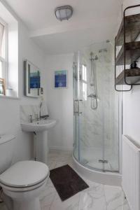 a bathroom with a shower and a toilet and a sink at SEA HEIGHTS MARGATE in Margate