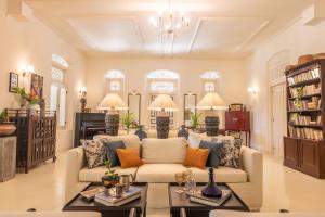 a living room with a couch and a table at The Sun House in Galle