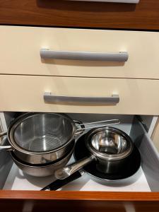 dos ollas y sartenes en la parte superior de un cajón en Apartament Viva Predeal, en Predeal 32 fotos más