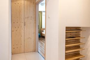 a hallway with wooden walls and a sliding door at Sunny apartment in Trnava in Trnava +5 photos