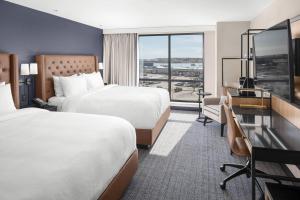 a hotel room with two beds and a desk at Courtyard by Marriott Portland Downtown/Waterfront in Portland