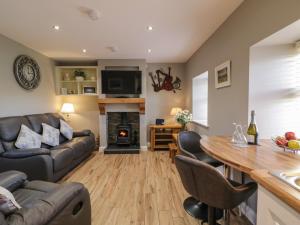 a living room with a couch and a table at Lough Island Reavy Cottage in Newry