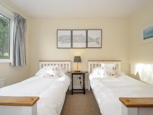 two beds sitting next to each other in a room at Trevega in Polzeath