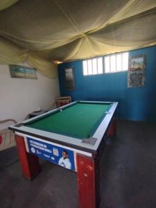 a room with a pool table in a tent at Pousada Maravilha Geribá in Búzios
