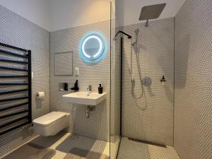 a bathroom with a shower and a toilet and a sink at SPA SPA Apartments Vyšehrad in Prague