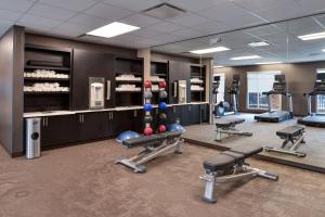 a fitness room with cardio equipment and weights at Residence Inn Visalia in Visalia