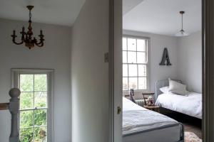 a bedroom with a bed and a window at Trinity Square Georgian Townhouse in Margate