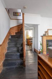 a hallway with a staircase in a house at Turner Cottage - 3 bed with a View of the Harbour in Margate