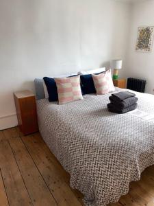 a bedroom with a large bed with pillows on it at Turner Cottage - 3 bed with a View of the Harbour in Margate
