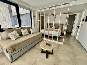a bedroom with a bed and a table in it at Playa Grande Apartment in Mar del Plata