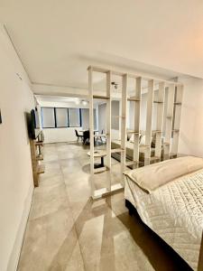 a bedroom with a bed and a living room at Playa Grande Apartment in Mar del Plata